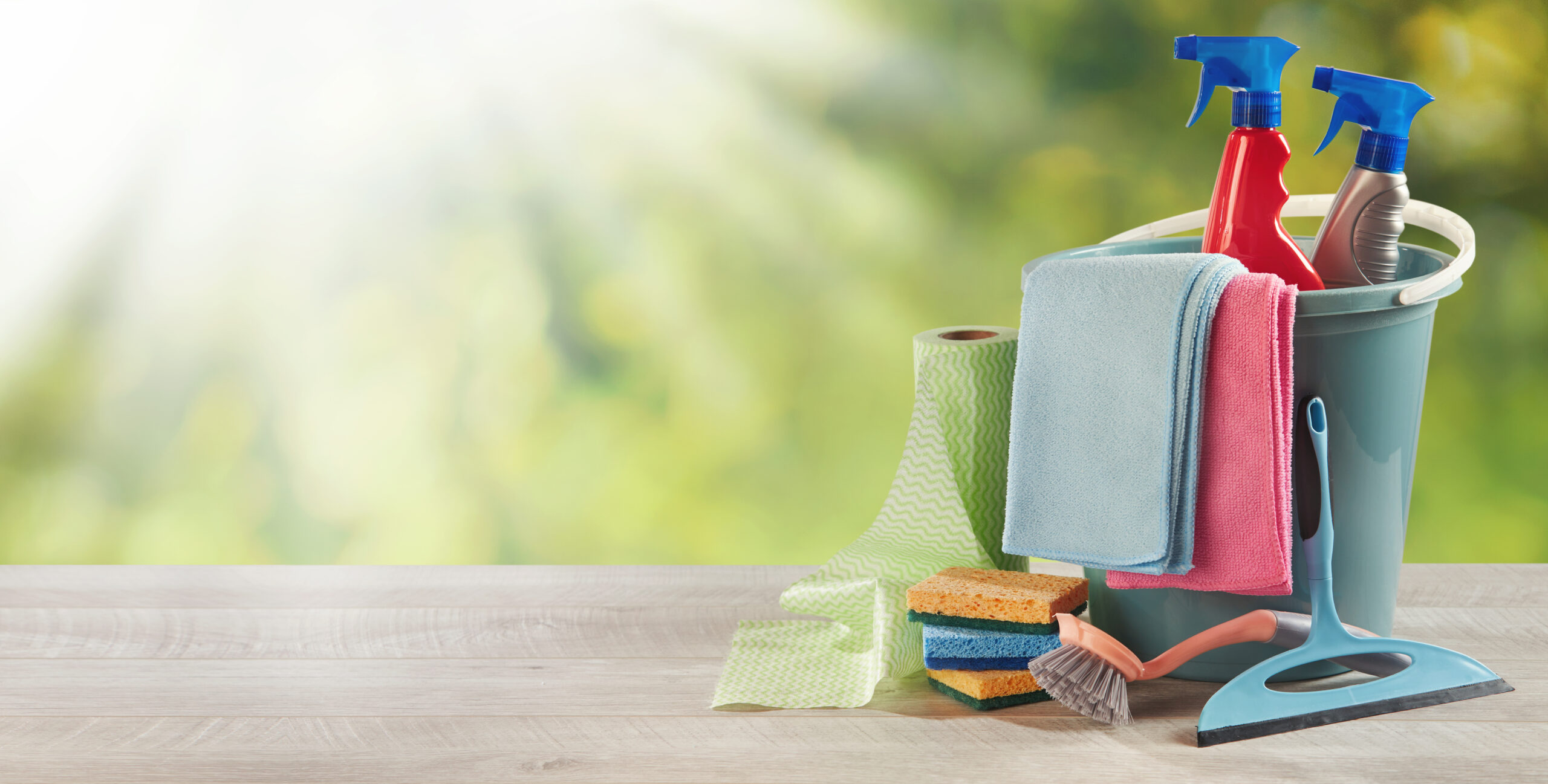 Household cleaning supplies on a garden table Household cleaning supplies on a garden table